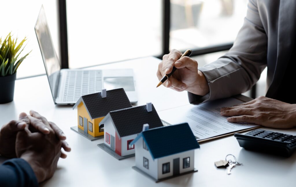 Real estate agents explain models of housing estates in projects.